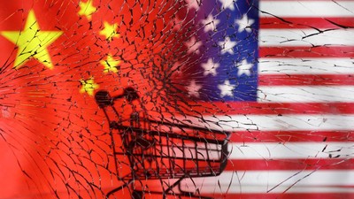 Shopping cart is seen through broken glass in front of U.S. and Chinese flag displayed in this illustration taken January 30, 2023. REUTERS/Dado Ruvic/Illustration