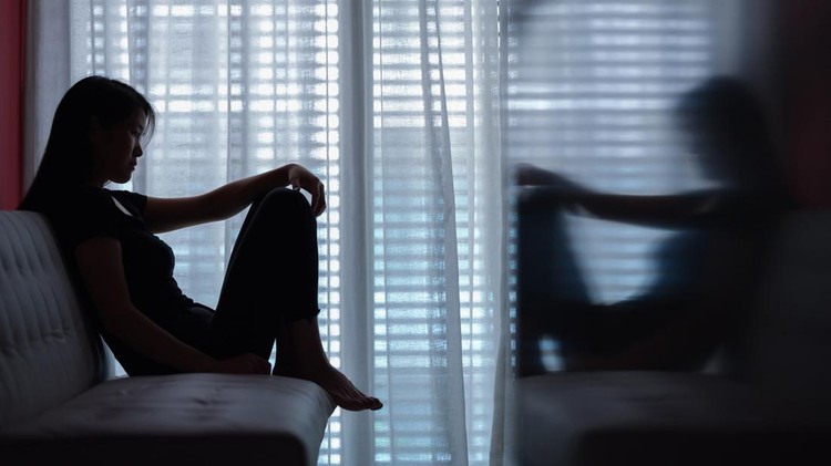 1238290012 sad woman seating alone