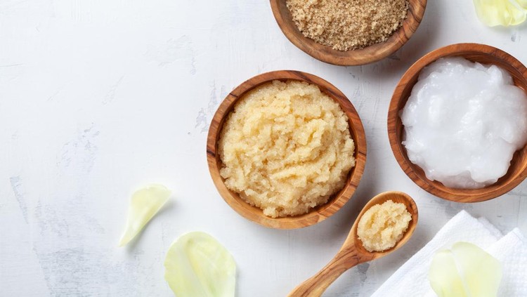 1209066846 Sugar body scrub with ingredients on white stone table. Homemade cosmetic for spa and beauty with copy space.