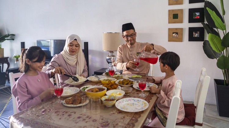 happy muslim family ready for Iftar or breaking fast meal in Ramadan.