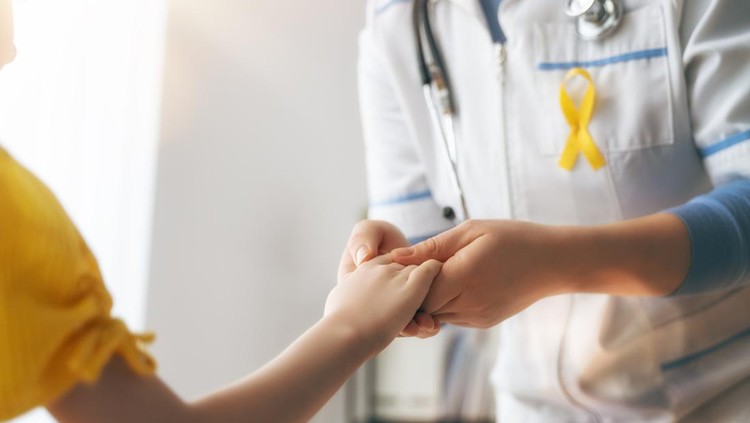 World Childhood cancer Day. Girl patient listening to a doctor in medical office.