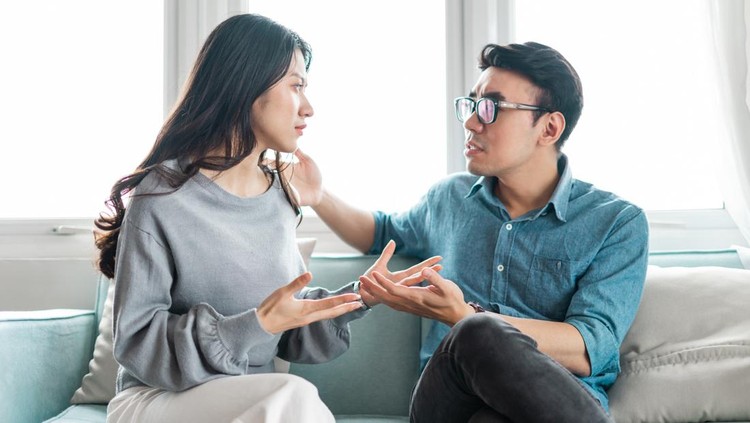 Asian couple arguing at home