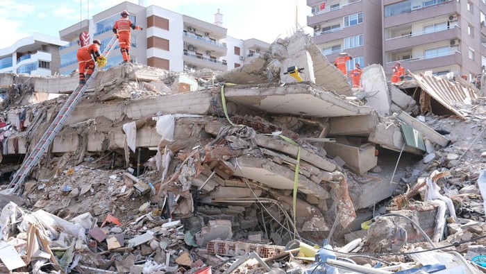Izmir, Turkey 11/01/2020: Emergency services personnel search a collapsed building for survivors after a powerful earthquake struck on October 30, 2020 in Izmir, Turkey. 92 people have been killed and more than 900 were injured after an earthquake struck the Aegean Sea off the coast of Turkey's Izmir Province. More than twenty buildings were destroyed in Izmir, Turkey's third largest city
