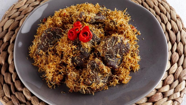 1336682913 Dendeng ragi or serundeng or saur is Indonesian spicy coconut flakes, made from sauted grated coconut with slices beef, spices, and herbs.