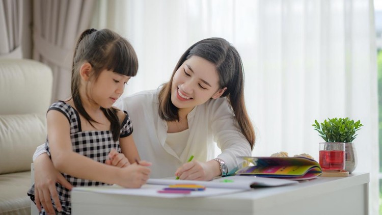 modern mother joining homework together with daughter, happy time in living home and comfortable feel free