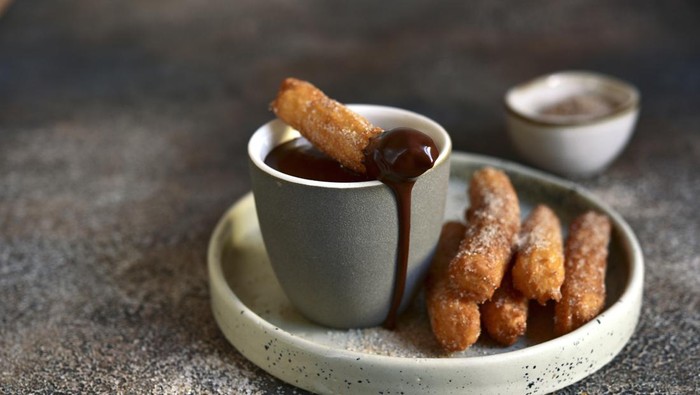 German donuts with jam and icing sugar. Carnival powdered sugar raised donuts.