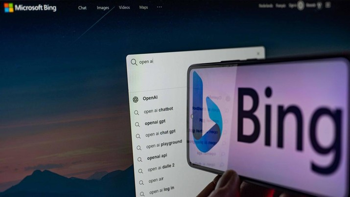 Microsoft Bing  - OpenAI seen in double exposure  displayed on screen and mobile. On 12 February 2023 in Brussels, Belgium.  (Photo illustration by Jonathan Raa/NurPhoto via Getty Images)