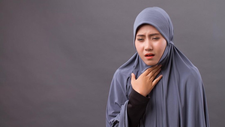 sick muslim woman coughing with cold or sore throat