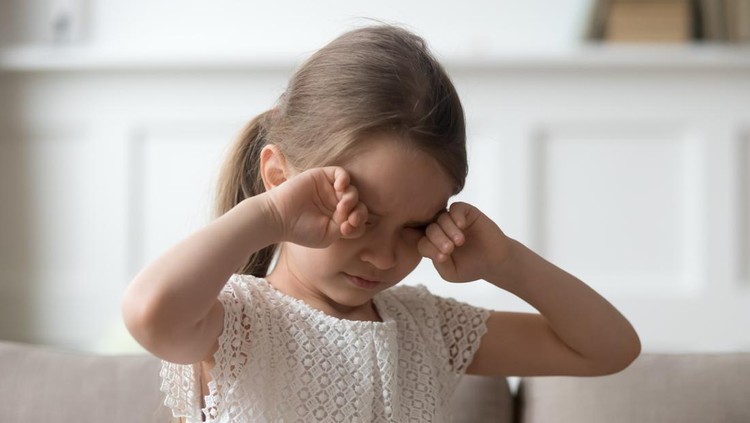 Ilustrasi Kanker Mata Sleepy stressed tired upset little child crying rubbing eyes feel abused hurt pain, sad lonely worried preschool kid girl in tears miss parents sitting on sofa alone, unhappy children emotion concept
