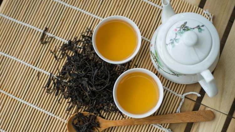 Cup with green tea on the table.