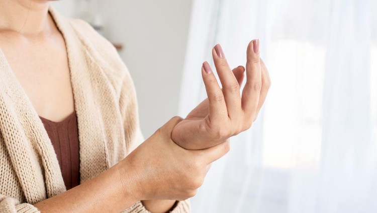 woman suffering from wrist pain, numbness, or Carpal tunnel syndrome hand holding her ache joint