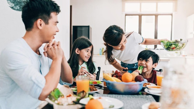 Asian ethnicity family having breakfast at home