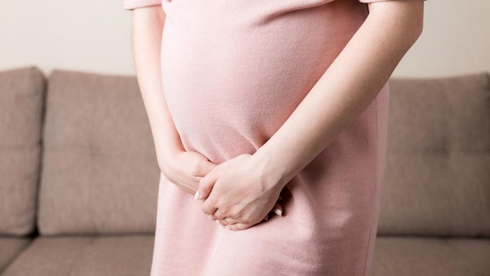 urinary incontinence during pregnancy. Abdominal pain during pregnancy. Maternity healthcare concept .