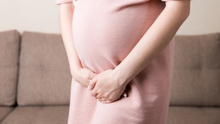 ibu hamil urinary incontinence during pregnancy. Abdominal pain during pregnancy. Maternity healthcare concept .