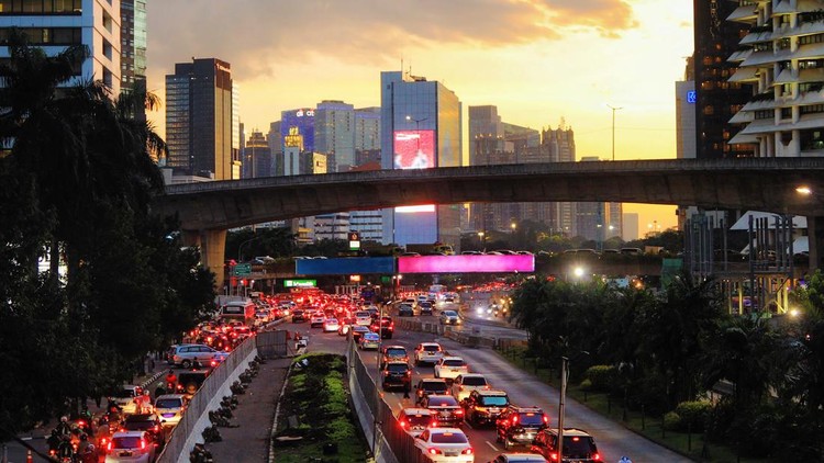 1345196315 Downtown Jakarta busy city scene at sunset with heavy traffic un the highway under the overpasses.