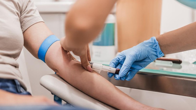 Close-up Of Doctor Taking Blood Sample From Patient's Arm in Hospital for Medical Testing