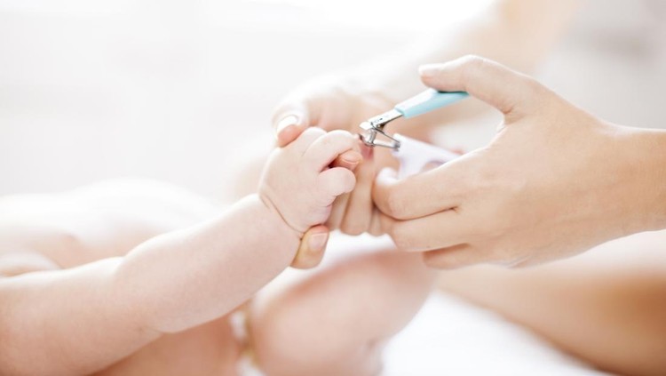 Mother cutting baby's nails