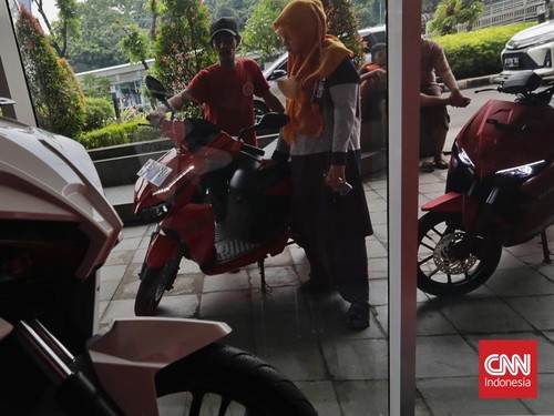 Calon pembeli mengamati motor listrik Gesits Raya di tempat penjualan dan servis resmi di kawasan The Hive, Jakarta, Sabtu, 11 Maret 2023. Pemerintah memutuskan segera menggulirkan insentif untuk kepemilikan sepeda motor listrik bagi para pelaku usah