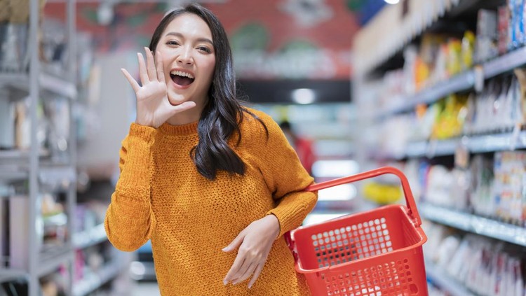happiness cheerful exited asian female woman casual cloth hand hold empty shopping basket hand gesture announce good news or new promotion to camera,asian female smiling in supermarket groceries mall