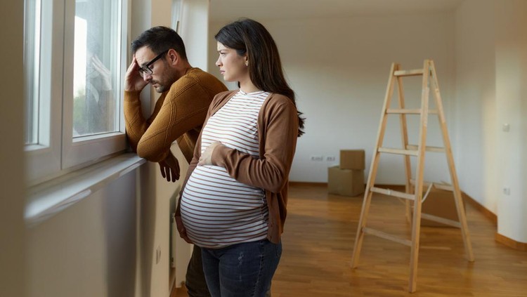 1447109015 Displeased expecting couple having problems after moving into a new apartment. Copy space.