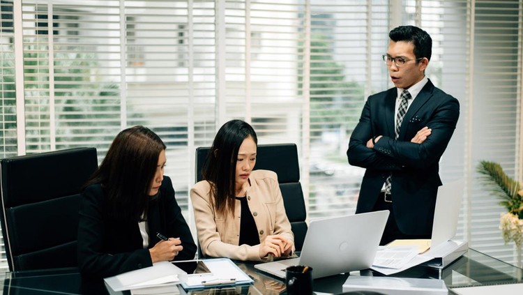 1367300586 An Asian Manager is insulting his colleague in conference room.