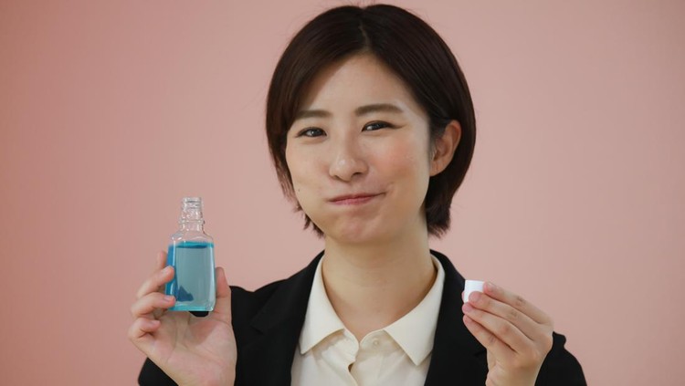1327391489 Woman with mouthwash