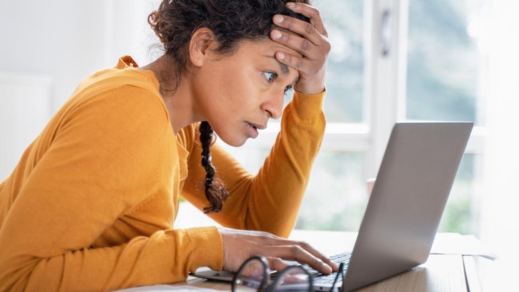 Black woman worried reading bad news on internet