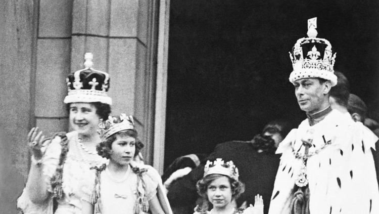 The crowned King George VI and Queen Elizabeth with Princess Elizabeth and Princess Margaret Rose, acknowledging the cheers of the crowd from the balcony of Buckingham Palace on their return from Westminster Abbey.
