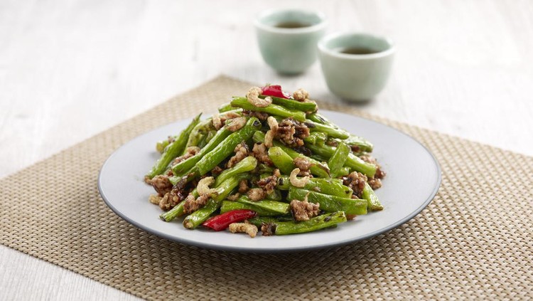 Stir-fried French Beans with Minced Pork and Preserved Olive Vegetables with chopsticks served in a dish isolated on mat side view on grey background