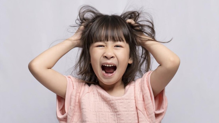 Angry Asian girl on white background, angry child, frantic gesture expression and put his hand on his head.