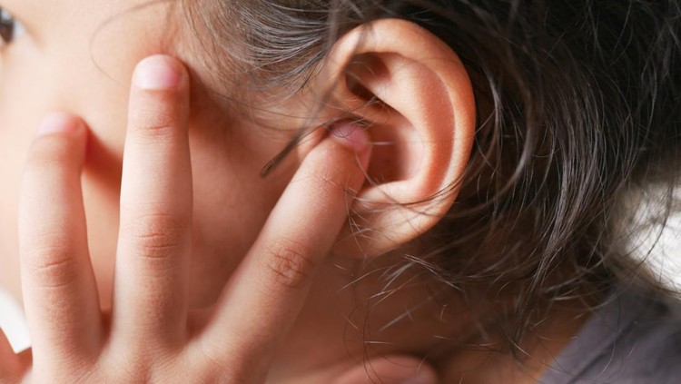 child girl having ear pain touching his painful ear ,.