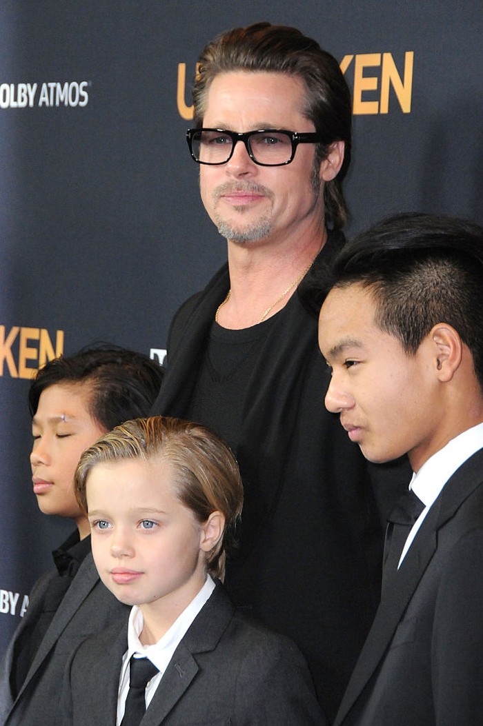 HOLLYWOOD, CA - DECEMBER 15:  (L-R) Pax Thien Jolie-Pitt, Shiloh Nouve Jolie-Pitt, actor Brad Pitt and Maddox Jolie Pitt attend the premiere of 'Unbroken' at TCL Chinese Theatre IMAX on December 15, 2014 in Hollywood, California.  (Photo by Barry King/FilmMagic)