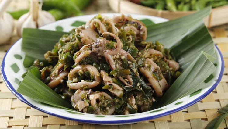 1403832787 Close Up Cumi Cabe Ijo, Spicy Stir Fry Squid with Green Pepper, Shallot, and Garlic. Served on Enamel Plate on Wooden Table
