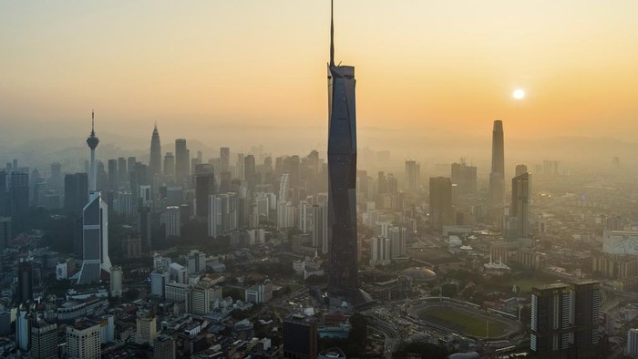 The sun rises over downtown Kuala Lumpur, Malaysia on April 11, 2023. (AP Photo/Vincent Thian)