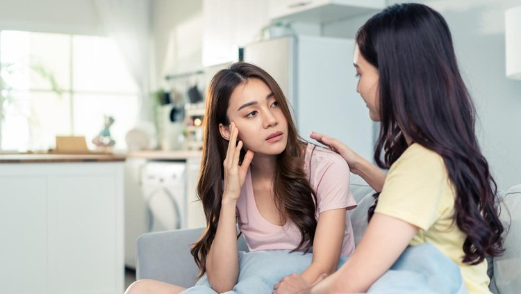 Asian beautiful woman comforts upset girl friend crying for problem. Attractive carring female support, consoling and understand empathy to stressed young sister in tears at home. Family relationship.