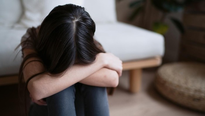 Sad teenager feeling bad alone holding head in hands, feeling depressed, regrets of mistake, having problems, adolescent girl with broken heart