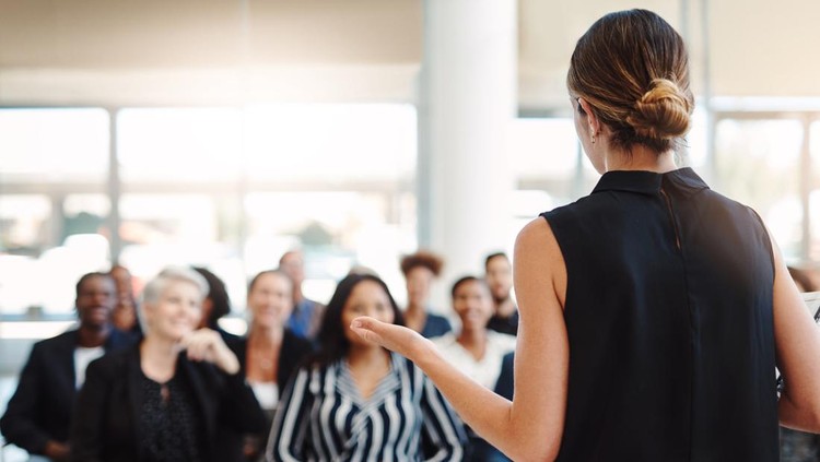 1141464027 Shot of a young businesswoman delivering a speech during a conference