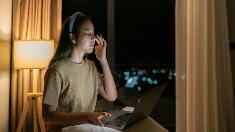 1333510568 Late night Asian women working on their laptops in bed don't forget to keep their faces looking good.