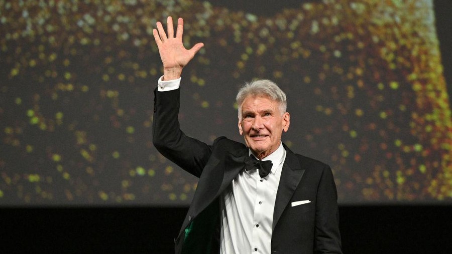 CANNES, FRANCE - MAY 18: Harrison Ford receives an honorary Palme D'Or from Iris Knobloch during the 76th annual Cannes film festival at Palais des Festivals on May 18, 2023 in Cannes, France. (Photo by Stephane Cardinale - Corbis/Corbis via Getty Images)