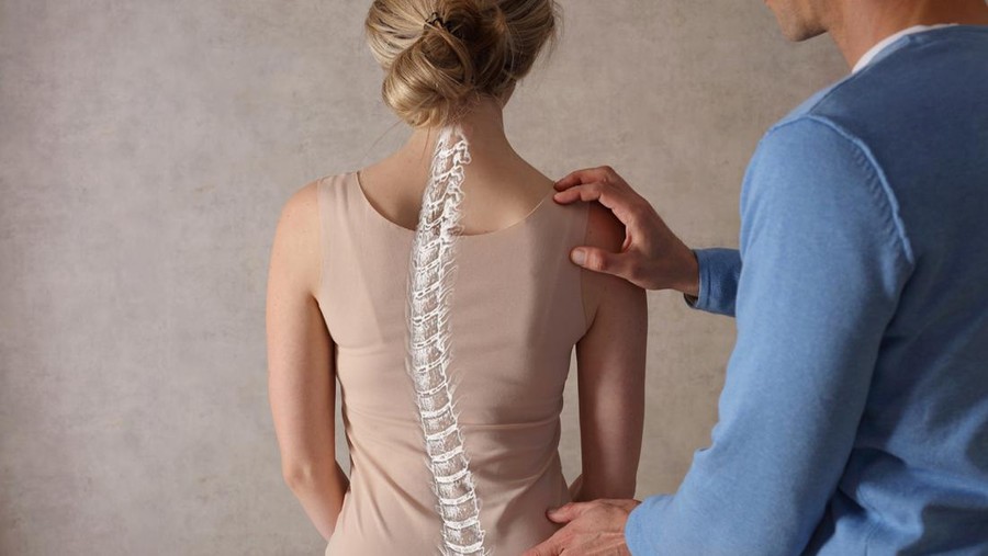 Woman suffering from back ache on the bed, healthcare and problem concept