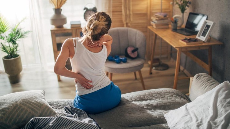 931082384 Woman suffering from back ache on the bed, healthcare and problem concept