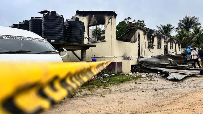 View of the school dormitory that caught fire and left at least 19 people dead in Mahdia, Guyana on May 22, 2023. At least 19 people, most of them youths, were killed and several injured Sunday in a school dormitory fire in Guyana, the government said in a statement, with the nation's president calling it a 