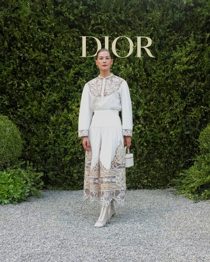 Gaya bohemian yang lebih romantis ditampilkan Rosamund Pike lewat padanan atasan dan rok aksen bordir dan renda serta sepatu boots. Foto: Courtesy of Dior