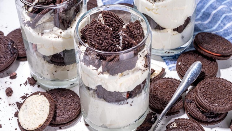 1481371965 Cream and cookie layered dessert. Homemade oreo trifle, vanilla chocolate cookie layered cheese cake in glass, variation of traditional american breakfast dessert