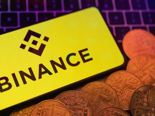 Smartphone with displayed Binance logo and representation of cryptocurrencies are placed on a keyboard in this illustration taken, June 8, 2023. REUTERS/Dado Ruvic/Illustration