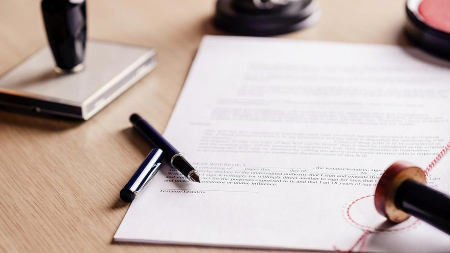 506603586 Notary pen lying on testament. Notary public working accesories