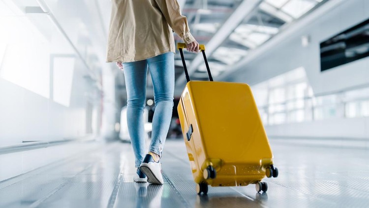 International airport terminal. Asian beautiful woman with luggage and walking in airport