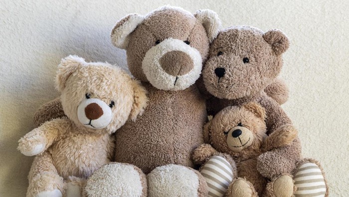 Happy teddy bear family (parents and two children) portrait