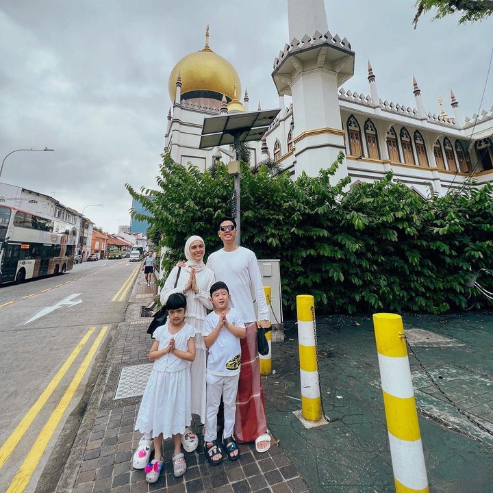 <p>Tahun ini, pasangan Nycta Gina dan Rizky Kinos merayakan Idul Adha jauh dari rumah. Gina dan Kinos bersama dua anak mereka melaksanakan salat Idul Adha di Masjid Sultan, Singapura. Gina dan Kinos memang tengah berada di Singapura untuk liburan keluarga. (Foto: @missnyctagina).</p>