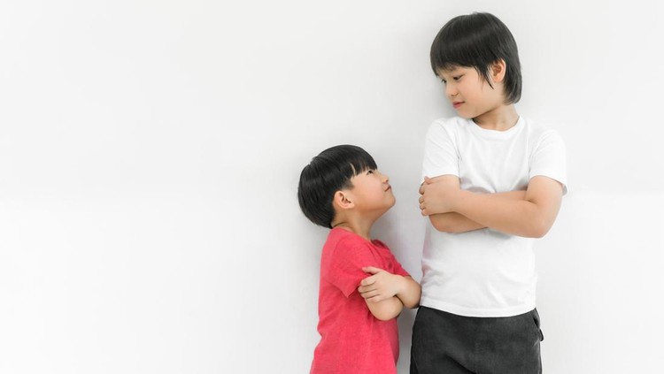 Little child boy and tall child boy standing arms crossed and looking face isolated on white background. Big and small kid concept at be friends. Back to school for concept.
